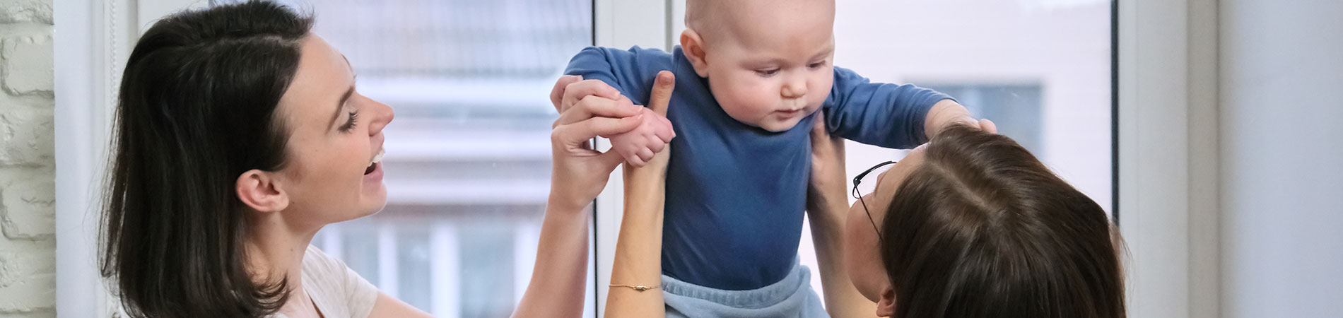 image of toddler being helped