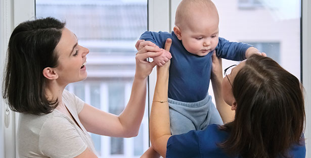 image of toddler being picked up